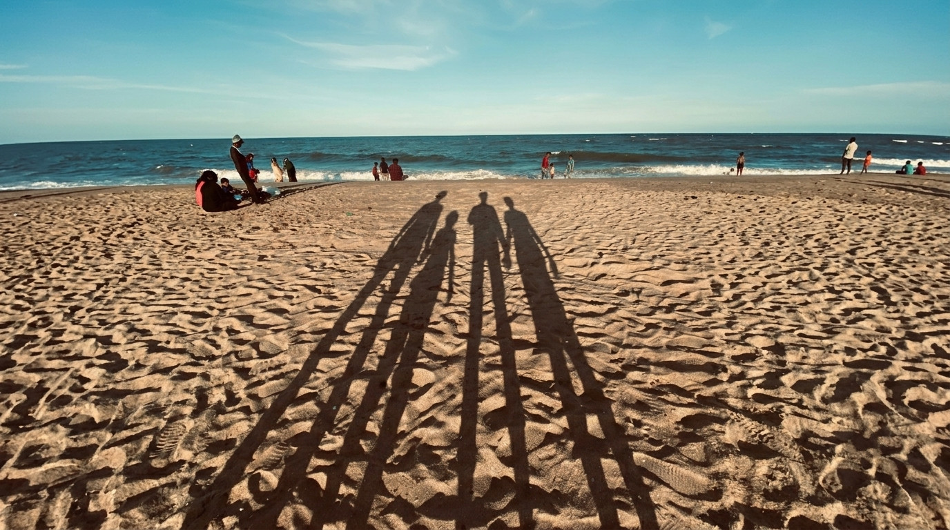 Sombras de una familia en la playa durante las vacaciones de verano